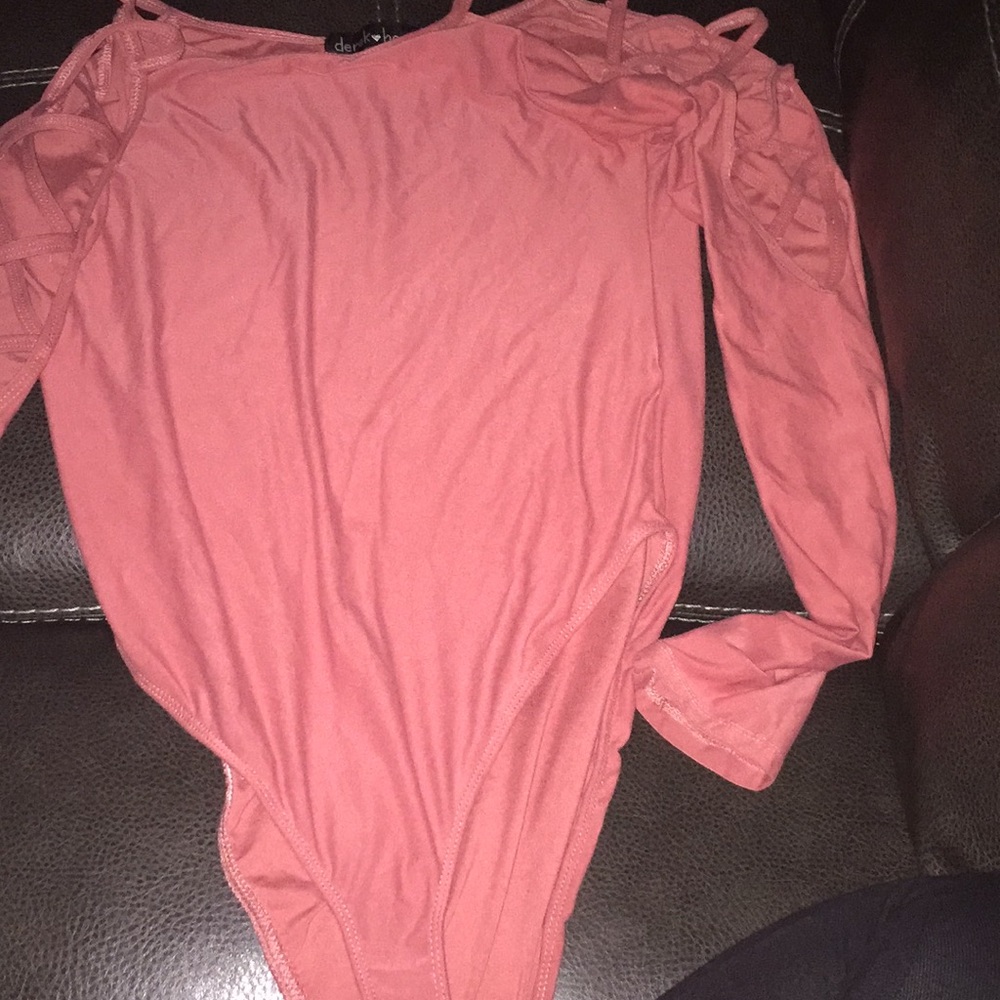 a peach bodysuit with cut out arms , worn once